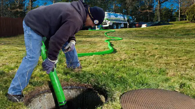 Service technician performing residential septic pumping and drainage maintenance in Oakland, CA